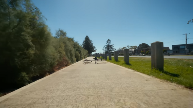 Bike path with a bike lying on its side in the middle of the path